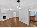 Hardwood floored living room featuring a fireplace and a decorative chandelier at 1438 N Crossing Ne Dr, Atlanta, GA 30329