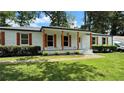 Inviting white brick home featuring a cozy front porch with wooden columns and shutters adding warmth at 2678 Stardust Trl, Decatur, GA 30034