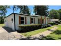Angle view of painted brick home featuring matching garage with natural wooden shutters and well manicured lawn at 2678 Stardust Trl, Decatur, GA 30034