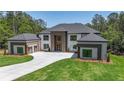 Stunning two-story home featuring a symmetrical design and large front yard with a long private driveway at 2843 N North Bogan Rd, Buford, GA 30519
