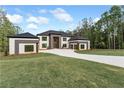 Well-manicured lawn leads up to this stunning modern home with unique architecture and design at 2843 N North Bogan Rd, Buford, GA 30519