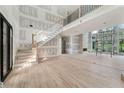 Open-concept living space boasts hardwood floors, high ceilings, staircase, and ample natural light at 2843 N North Bogan Rd, Buford, GA 30519