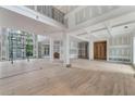Spacious living room with hardwood floors, tall ceilings, and large windows offering natural light at 2843 N North Bogan Rd, Buford, GA 30519