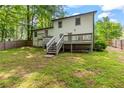 Fenced backyard with a deck and stairs perfect for outdoor entertaining and relaxation at 4723 N Springs Nw Rd, Kennesaw, GA 30144