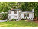 Charming home with white siding, brick accents, manicured lawn, and beautiful landscaping at 4723 N Springs Nw Rd, Kennesaw, GA 30144