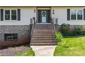 Close-up of entryway steps leading to a stylish front door with sidelights and decorative elements at 3441 Sherrod Sw Dr, Marietta, GA 30060
