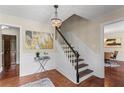 Elegant foyer featuring hardwood floors, wainscoting, a chandelier, and a staircase with dark wood treads at 3441 Sherrod Sw Dr, Marietta, GA 30060