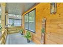 Charming front porch with wooden accents, decorative welcome sign, plants, and a hanging lantern at 3819 Shane Ct, Ellenwood, GA 30294