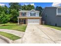 Well-maintained home with a spacious driveway and a manicured lawn in a residential neighborhood at 10786 Wheeler Trce, Hampton, GA 30228