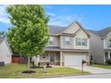 Charming home featuring a well-manicured lawn, beautiful landscaping, and a two car garage at 196 Boulder Run, Hiram, GA 30141