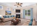 Cozy living room features a fireplace, plush carpet, and large windows for natural light at 196 Boulder Run, Hiram, GA 30141