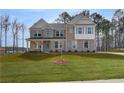 Beautiful two-story home boasting a brick facade and meticulously maintained front lawn at 520 Dulles Dr, Mcdonough, GA 30253