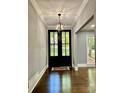 Inviting foyer featuring hardwood floors, modern lighting, and a view through to the front yard at 1230 Sunderland Ne Ct, Brookhaven, GA 30319