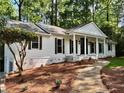 Beautifully renovated home with a white exterior, stone pathway, and a covered front porch at 1230 Sunderland Ne Ct, Brookhaven, GA 30319