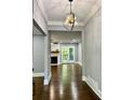 View of the living room with hardwood floors, fireplace, and view into the kitchen at 1230 Sunderland Ne Ct, Brookhaven, GA 30319
