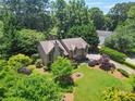 Expansive aerial view of a beautiful home surrounded by lush greenery and mature trees providing privacy at 150 Victoria Sta, Woodstock, GA 30189