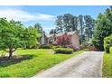 Charming two-story home with mature trees on a well-manicured lawn provides a desirable curb appeal at 150 Victoria Sta, Woodstock, GA 30189