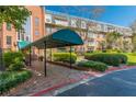 Multi-story brick building with balconies and a green awning over the entryway at 28106 Plantation Ne Dr, Atlanta, GA 30324