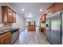 Open kitchen with wood cabinets, granite countertops, stainless appliances, adjoining living spaces at 3460 Village Park Sw Ln, Atlanta, GA 30331