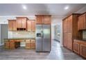 Modern kitchen boasting wooden cabinets, granite countertops, stainless appliances and wood-look floors at 3460 Village Park Sw Ln, Atlanta, GA 30331