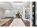 Grand foyer featuring hardwood floors, high ceilings, and an open view into the home's living spaces at 2410 Bridle Bridge Trl, Cumming, GA 30040