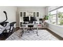 Well-lit office with a large window, built-in shelving, and a comfortable workspace, perfect for productivity at 2410 Bridle Bridge Trl, Cumming, GA 30040