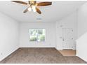 Bright living room featuring new carpet and a ceiling fan at 2530 Marlin Dr, Mcdonough, GA 30253