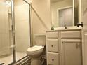 Cozy bathroom featuring a glass-enclosed shower, toilet and vanity at 261 Mahone Dr, Lilburn, GA 30047