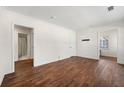 Spacious living room with hardwood floors and natural light from the large window at 3723 Glenwood Rd, Decatur, GA 30032