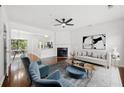 Bright living room with fireplace, ceiling fan, and plush seating at 1135 Kilmington Ct, Alpharetta, GA 30009
