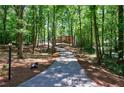 Long driveway winding through a wooded lot leading to a classic brick home at 1348 Timberland Se Dr, Marietta, GA 30067