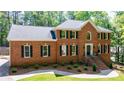 Beautiful brick home featuring a well-manicured lawn and classic architectural details at 1348 Timberland Se Dr, Marietta, GA 30067