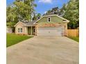 Beautiful home features a well-maintained lawn, stone accents, and an attached two car garage at 6022 Fieldcrest Dr, Morrow, GA 30260