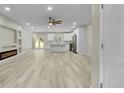 This open-concept living space has recessed lighting, a ceiling fan, built-in shelves, and an electric fireplace at 6022 Fieldcrest Dr, Morrow, GA 30260