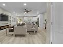 Open-concept living space with recessed lighting, ceiling fan, built-in shelves, and an electric fireplace at 6022 Fieldcrest Dr, Morrow, GA 30260