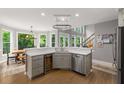 Bright eat-in kitchen featuring stainless steel appliances, granite counters and hardwood floors at 10410 High Falls Cir, Alpharetta, GA 30022