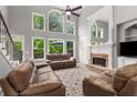 Cozy living room with a fireplace, large windows, and comfortable seating at 10410 High Falls Cir, Alpharetta, GA 30022