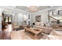 Comfortable living room with coffered ceiling, plush seating, and stylish decor at 12980 Overlook Pass, Roswell, GA 30075