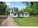 Attractive one-story home boasting a covered porch, a blue front door, and a well-maintained lawn, perfect for a Gathering at 3952 Leisure Se Ct, Conyers, GA 30013