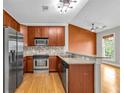 Well-equipped kitchen featuring stainless steel appliances, granite countertops, and wooden cabinets at 1628 Briarcliff Ne Rd # 15, Atlanta, GA 30306