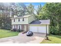 Traditional two-story home with a two-car garage, a green lawn, and a concrete driveway at 2722 Springside Ct, Douglasville, GA 30135