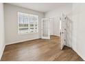 Bright office space with a large window, stylish flooring, and glass paneled doors at 719 Hedwig Dr, Mcdonough, GA 30252