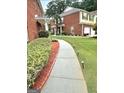 Manicured front yard with green grass, sidewalk and planting bed at 988 Treymont Way, Lawrenceville, GA 30045