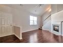 Spacious living room with fireplace, hardwood floors, staircase, and lots of natural light at 1015 Lakeside Cir, Covington, GA 30016