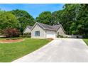 View of the exterior of this well maintained home with attached two car garage at 130 Lacey Oak Ln, Loganville, GA 30052