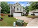 Charming two-story home with a two-car garage, landscaped front yard, and a combination of siding and stone exterior at 3265 Watson Gate Rd, Loganville, GA 30052