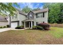 Charming two-story home with a two-car garage, landscaped front yard, and a combination of siding and stone exterior at 3265 Watson Gate Rd, Loganville, GA 30052