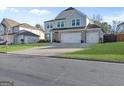 Charming two-story home with gray siding and a two-car garage at 3560 Summerpoint Xing, Cumming, GA 30028