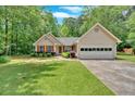 Charming single-Gathering home featuring a well-maintained lawn and attached two car garage at 3663 Homewood Trl, Powder Springs, GA 30127