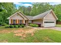 Charming single-Gathering home featuring a well-maintained lawn and attached two car garage at 3663 Homewood Trl, Powder Springs, GA 30127